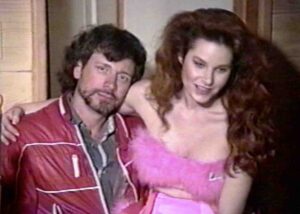 pirromount actress Monique Parent sits on the lap of director Mark Pirro on the set of "Buford's Beach Bunnies" (1992)