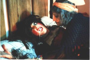 Michael Palazzolo puking up something while actress Sharon Alsina mounts him