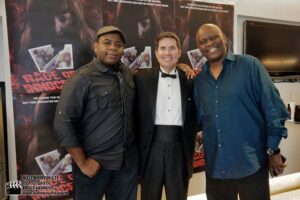 Actors Keeshan Giles, John McCafferty and Tyrone Dubose in front of Rage of Innocence poster